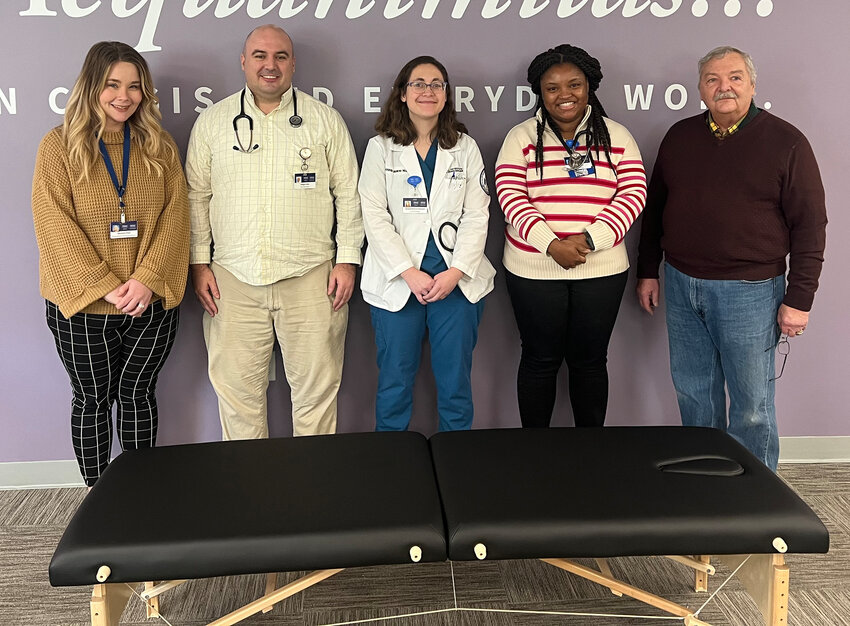 POMA donates an osteopathic treatment bed to The Wright Center. Pictured are Samantha Ponce, National Network Program coordinator at The Wright Center, left; A.T. Still University School of Osteopathic Medicine students Douglas Fisher, Amanda Munkres McDonald and Sandy Durosier; and Dr. Swallow...