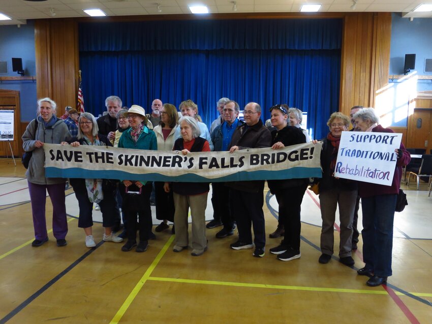 Supporters of traditional rehabilitation held up a banner while chanting, &quot;Whose bridge? Our bridge!&quot;