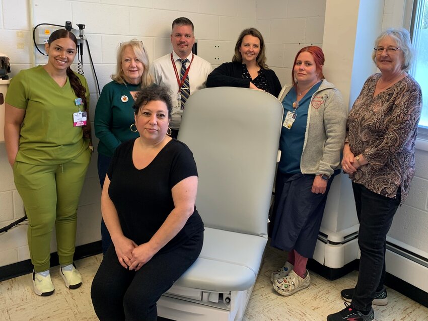 Garnet Health Doctors&rsquo; staff and Grover M. Hermann Auxiliary officers show off the new power lift examination table. Pictured, seated, is Gina Napolitano. In the back row are Destiny Arroyo, left; Peggy Richardson; Jason King; Christina Wood; Deanna Calabrese; and Tess McBeath.