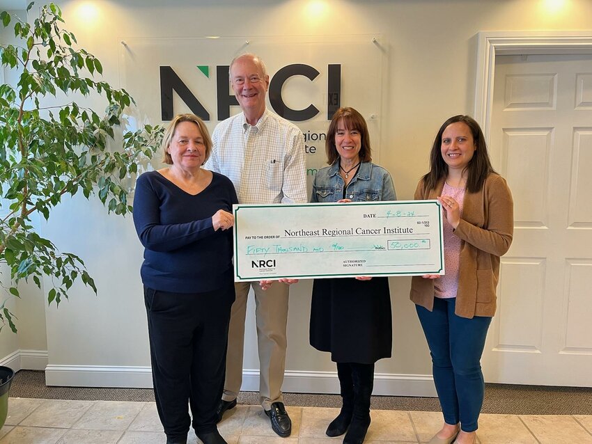 The Hawk Family Foundation presents a donation check to the Northeast Regional Cancer Institute. Pictured are Ann Hawk and Dave Hawk, founders of the Hawk Family Foundation, left; Laura Toole of Northeast Regional Cancer Institute; and Maggie Hawk of the Hawk Family Foundation...