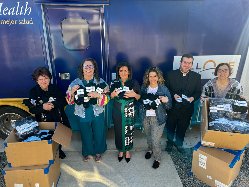 The Wright Center for Patient &amp; Community Engagement (PCE) received 10,000 pairs of Bombas socks to distribute to people experiencing homelessness and residents who are going through financial hardship or emergency situations. Participating in the delivery of the donation are Mary Marrara, left; Linda Thomas-Hemak; Kara Seitzinger; Helayna Szescila; the Rev. Ryan Glenn; and Gerri McAndrew.