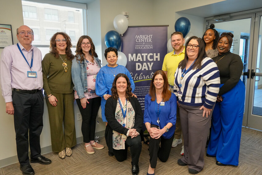 The Wright Center for Graduate Medical Education staff celebrated National Match Day on March 21,&nbsp;when they learned that 47 new resident physicians will join their residency programs.  Participating in the celebration, first row, from left, are Michelle Grochowski, graduate medical education  coordinator; Eileen Howells, designated institutional administrator; and Lisa Mann, graduate  medical educational&nbsp;coordinator. In the second row are Russell Day,&nbsp;graduate medical education  workforce operations, training and development specialist; Dr. Linda Thomas-Hemak, president  and CEO; Meagan Coleman-Derenick, director of GME assessment and evaluations; Dr. Jumee  Barooah,&nbsp;senior vice president of education and designated institutional official; Brian Ebersole,&nbsp;vice president of academic affairs and associate designated institutional official; Najla Figueroa, graduate medical education administrative assistant, and Xiomara Smith, clerkships coordinator.