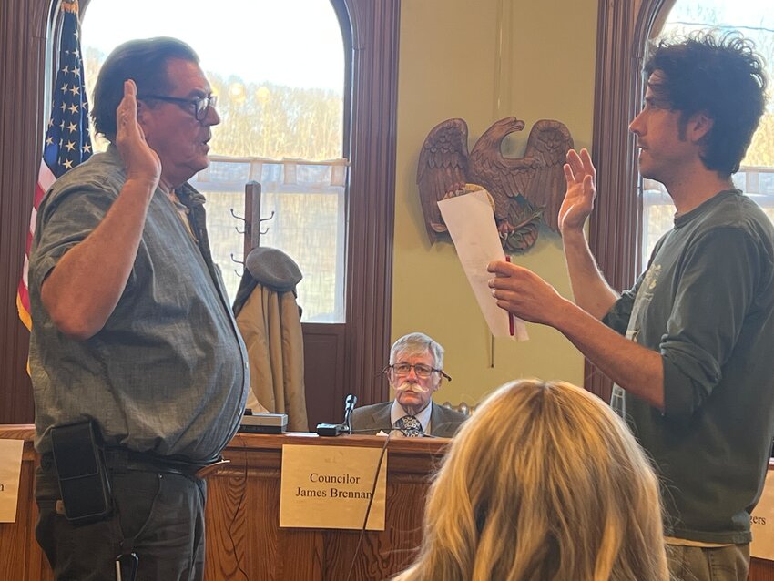 James Cordaro, left, being sworn in by Mayor Derek Williams.