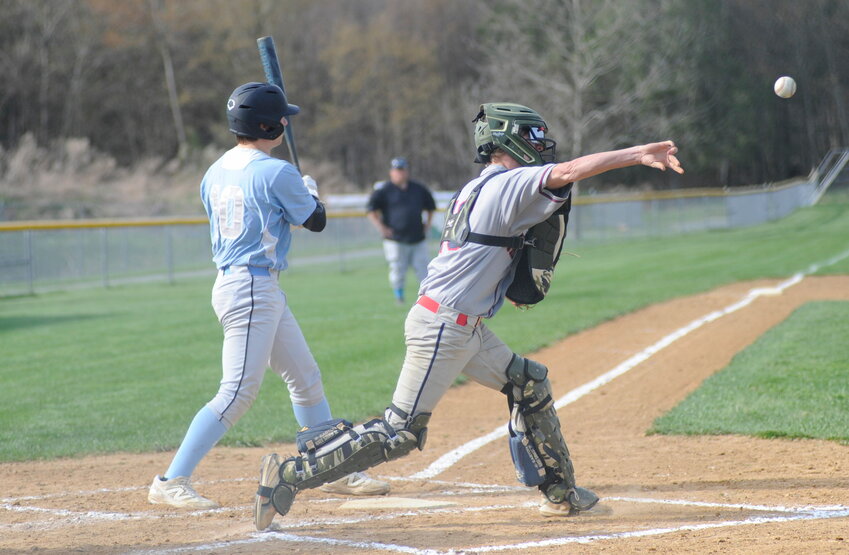 Peg to first. Tri-Valley&rsquo;s catcher Bryan Rogerson throws to first in an attempt to pick off a Bulldog, as Sullivan West&rsquo;s Todd Walter waits at the plate.