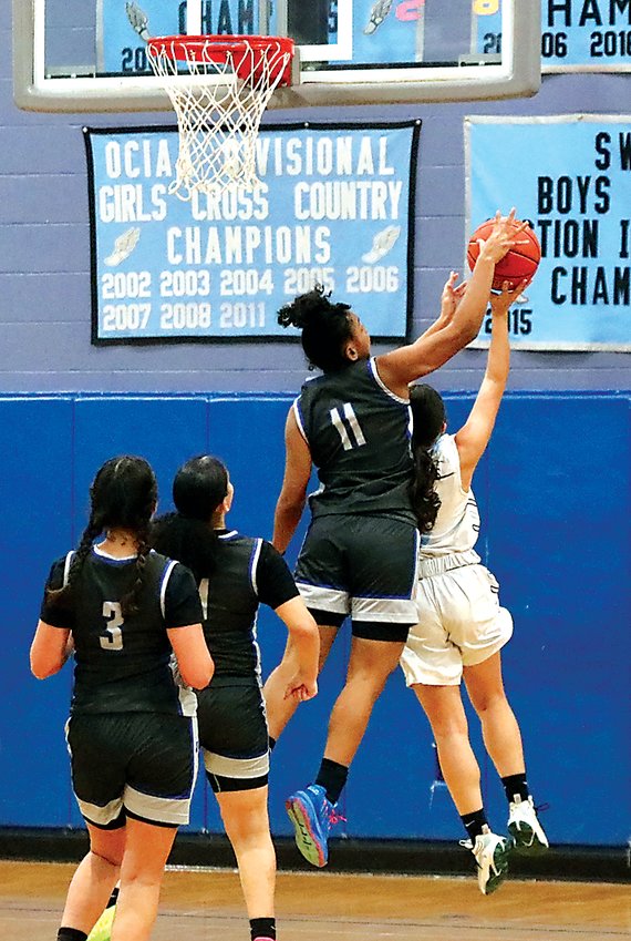A defensive force by dint of her quick feet and leaping ability, Mota averaged two blocked shots per game as evidenced by this all-ball rejection of Sullivan West guard Georgeanne Cardona’s attempted lay up.