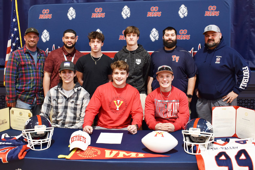 Dylan Poley signs to play at the Virginia Military Institute to play football. He poses for a photo surrounded by teammates and coaches that he hoisted the Section IX trophy with this year.
Standing from left to right, Justin Hartman (Coach), Marshon Williams (coach), Chris Russo (player), Zach Kitaychik (player), Kevin Crudele (coach), Tim Dymond (coach)
Sitting left to right, Collin Mentnech (player), Dylan Poley (player), Austin Hartman (player)