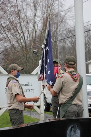 Members of Boy Scout Troop 97 raise a flag to honor all veterans during the Town of Neversink Flag Exchange at the Grahamsville Rural Cemetery.