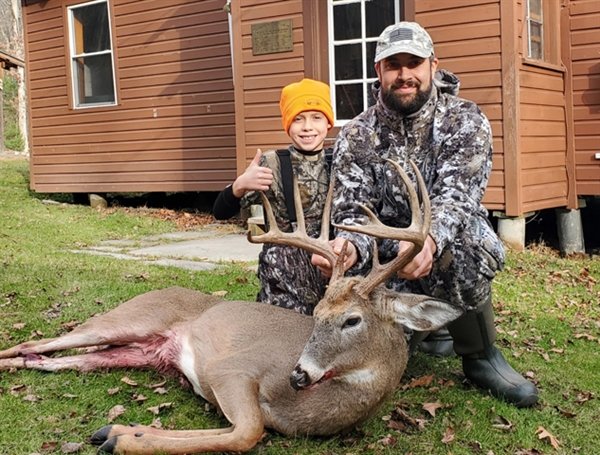Forest Darder with the monster whitetail he got on the opening day of Bow Season in the Town of Neversink. It measured 72.5 to win the Democrat's Big Buck Bow Contest. Helping him show off his buck is his son and future big buck hunter Jack Darder.