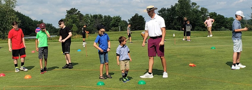 Instructor Joe Franke gives Swan Lake Golf &amp; Country Club campers golf instructions.