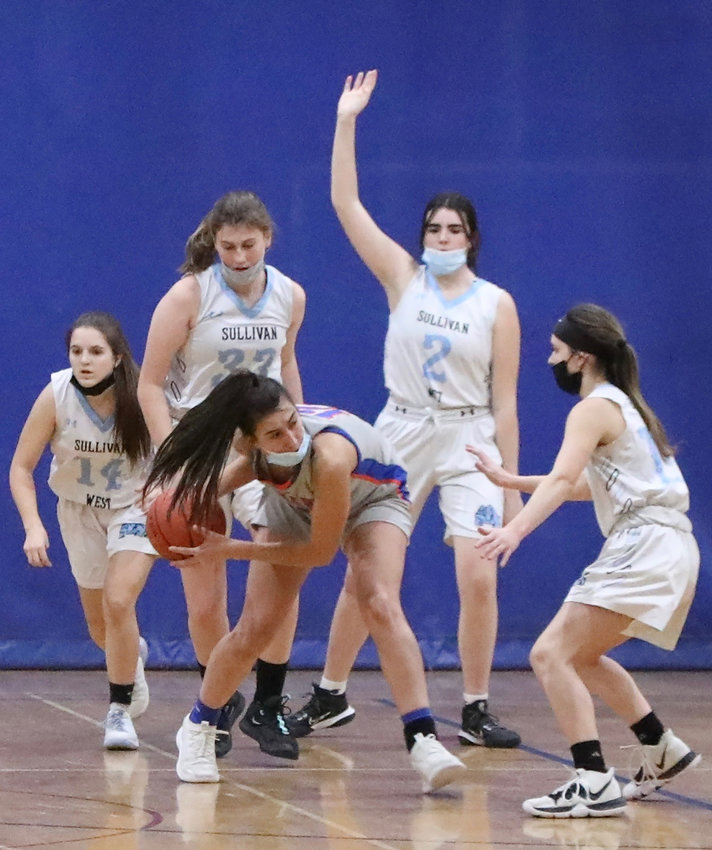 Sullivan West&rsquo;s patented aggressive defense hems in Seward star Shannon Sgombick as Grace Boyd, Brielle Arnott, Taylor Wall and Elaine Herbert fence her in. The idea was to deny her penetration and it mostly worked but she came up huge in the OT to help Seward bypass the Lady Westies.