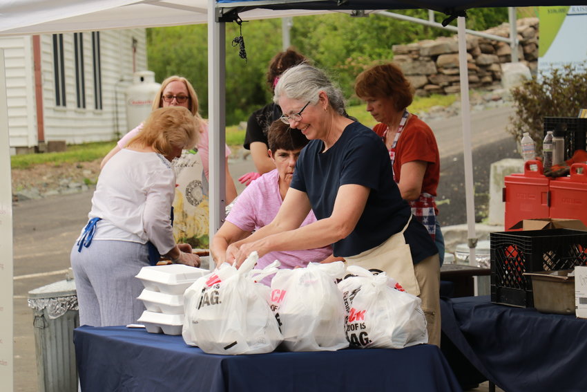 Volunteers packing up dinners at the 2021 BBQ. BBQ Chairperson, Anne-Marie Kremer of Claryville, is in the foreground.