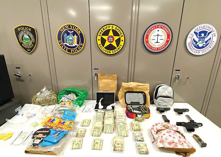 Contributed photo  A search warrant executed by multiple law enforcement agencies in the Village of Monticello last week seized dangerous drugs, handguns and more than $11,000 in cash.