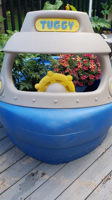 A Tuggy Tugboat kiddy pool makes for a great vacation plant waterer.