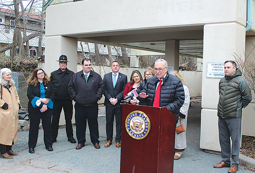 File photo by Matt Shortall   Senator Chuck Schumer (at podium) visited Catholic Charities on Broadway in Monticello in April calling for Sullivan County to be designated as a High-Intensity Drug Trafficking Area. He was joined (from left) by County Treasurer Nancy Buck, Chief Executive Officer for Catholic Charities Shannon Kelly, Sheriff Michael Schiff, Legislature Chairman Rob Doherty, State Senator Mike Martucci, District Attorney Meagan Galligan, Assemblywoman Aileen Gunther, County Division of Health and Human Services Deputy Commissioner and Sullivan County Drug Task Force Co-Chair Wendy Brown and County Division of Health and Human Services Commissioner John Liddle.
