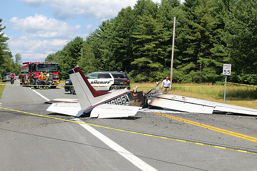 The Cessna 210 crash landed on Route 42 Friday afternoon after experiencing engine trouble. Pictured near the front of the plane is Sullivan County Sheriff&rsquo;s Office Detective Jack Harb.
