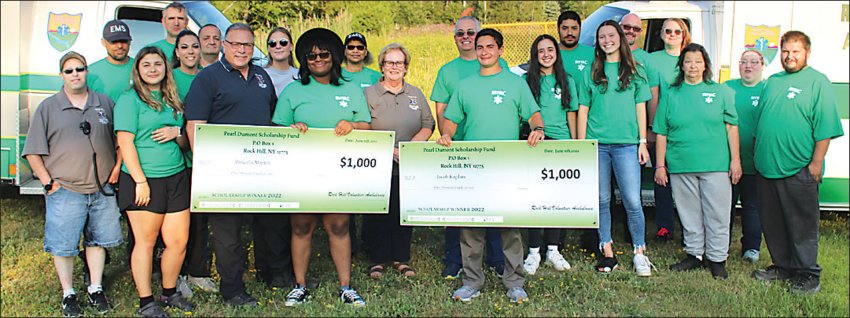 Rock Hill Volunteer Ambulance Corps volunteers and recent Monticello graduates Priscilla Martin and Jacob Kaplan (holding checks) were each recipients of the Pearl Dumont Scholarship Fund, which benefits Monticello students with plans to study in the medical field.