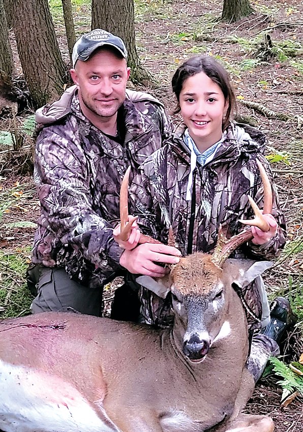 Arianna Kautz and her Dad pose with the first place winning buck that she harvested.
