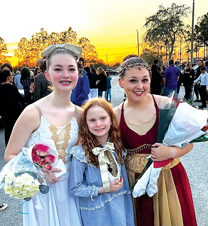 From left, Peyton Finch as Clara, Adeline holding one of her winning ballet slippers, and Emily Finch as Arabian.