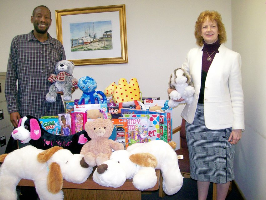 United Way Chief  Professional Officer Julian Dawson and Kiwanis Board Member Linda Barriger display donated games and toys.