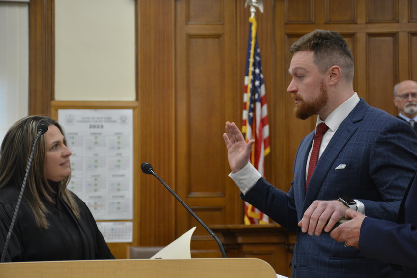 Acting District Attorney Brian Conaty, right, takes the oath of office, administered by his predecessor and mentor State Supreme Court Justice Hon. Meagan Galligan.