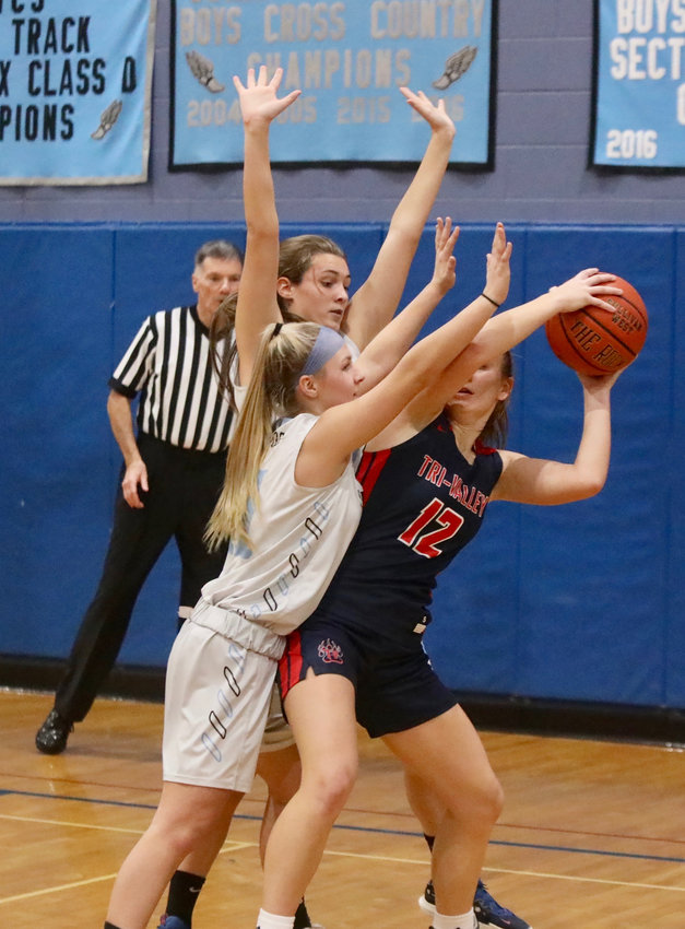 Sullivan West&rsquo;s Abby Parucki (foreground) and Felicity Bauerfeind hem in T-V&rsquo;s Mackenzie Closs. SW&rsquo;s defense was stifling and key in their 41-34 league win.