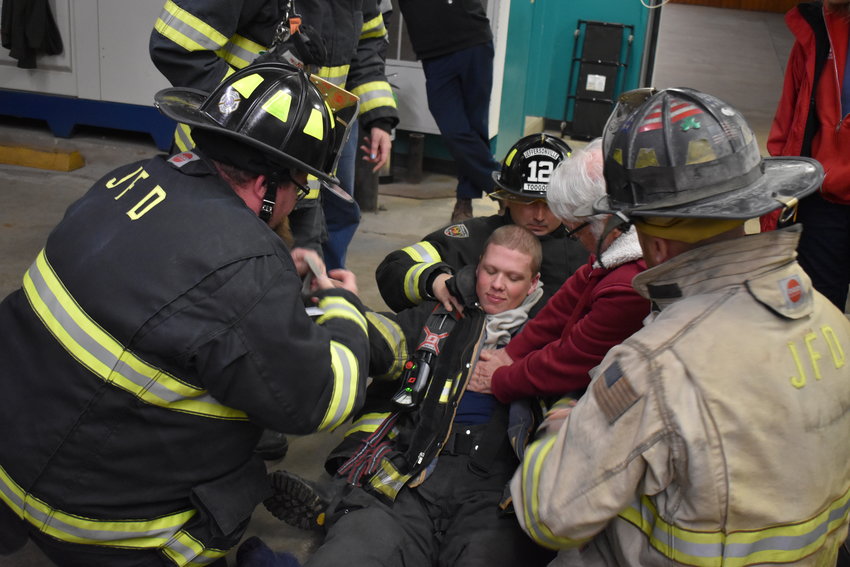 Position three and four are located near the legs of the downed firefighter. Their job unbuckle the SCBA (air pack) and remove the thumbs from the loops by the wrist to ease the head person&rsquo;s job.
