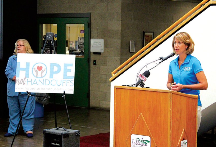 Annette Kahrs, CEO/Founder of the Tri-County Community Partnership, which administers the Hope Not Handcuffs (HNH) program is pictured at right, speaking at a press conference in July 2021, when the program was launched in Sullivan County. HNH recently partnered with the District Attorney&rsquo;s Office on a grant which will expand the program in the County.
