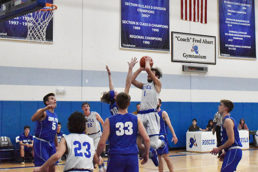 Anthony Teipelke drives through traffic for a mid-range jumper surrounded by Lions. Chapel Field&rsquo;s press and zone smothered the Roscoe offensive efforts in the league win on Monday night.