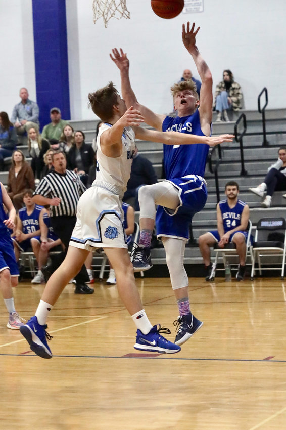 Roscoe&rsquo;s Aidan Johnston launches an off-balance shot over Sullivan West&rsquo;s Evan Ebert. Johnston posted 13 points in the win. Coach Mike Hill credited his relentless toughness.
