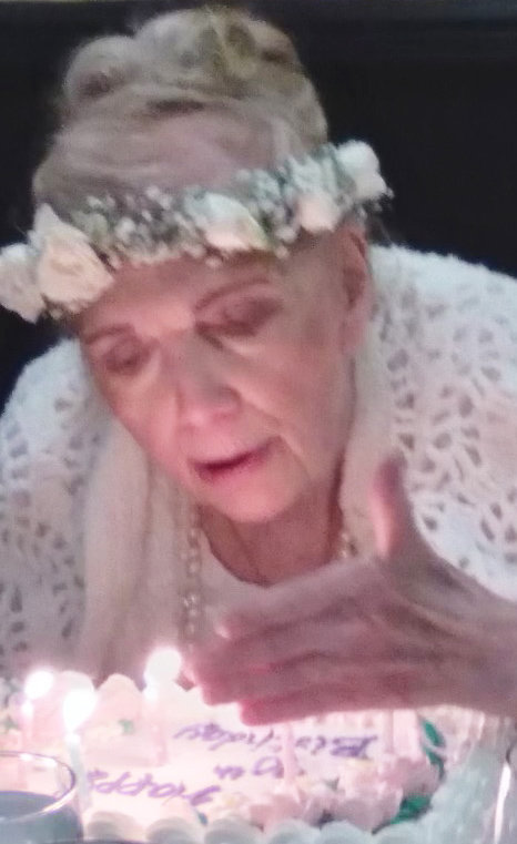 Barbara Festa blowing out the candles for her 90th birthday.