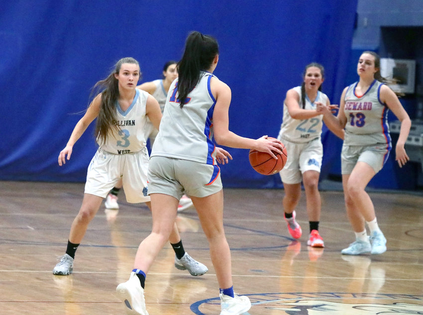 Sullivan West&rsquo;s Felicity Bauernfeind prepares to defend against Seward&rsquo;s Shannon Sgombick. The Seward standout scored a game-high 15 points, while Sullivan West struggled to keep pace.