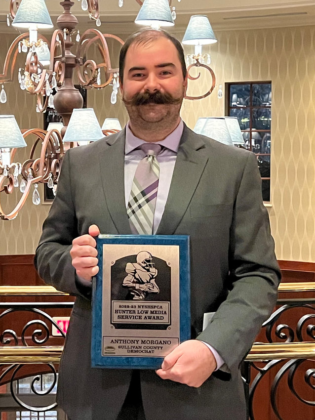 Sullivan County Democrat Sports Editor Anthony Morgano shows off his Hunter Low Media Service Award that he received from the New York State High School Football Coaches Association.