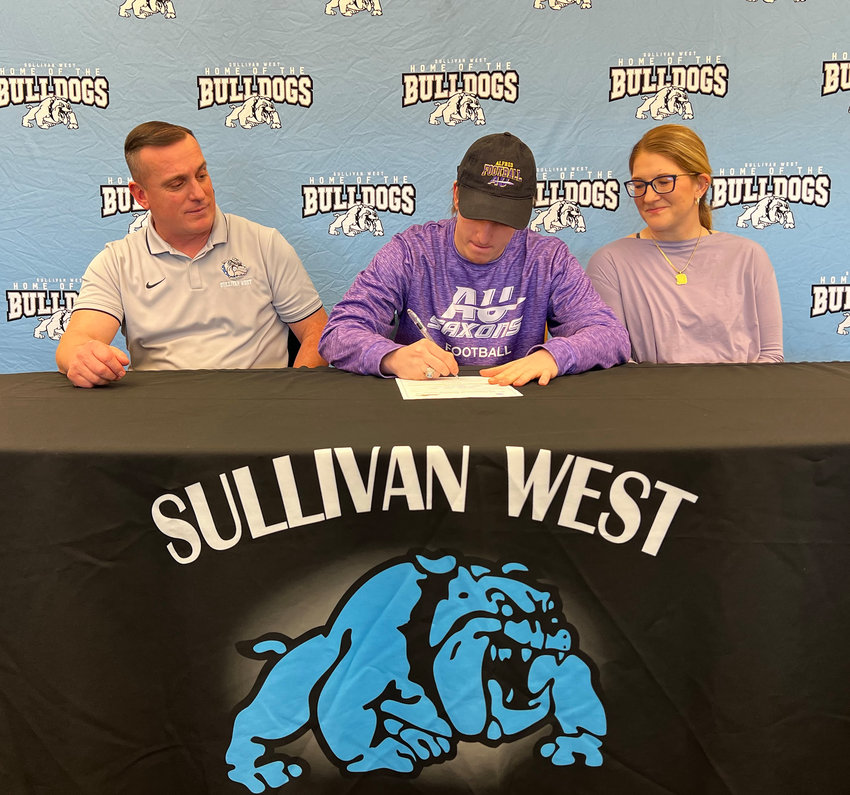 Sullivan West senior quarterback Jaymes Buddenhagen signs a letter of intent to play at Division III Alfred University. He is flanked by his father Kurt and his mother Ashlea.