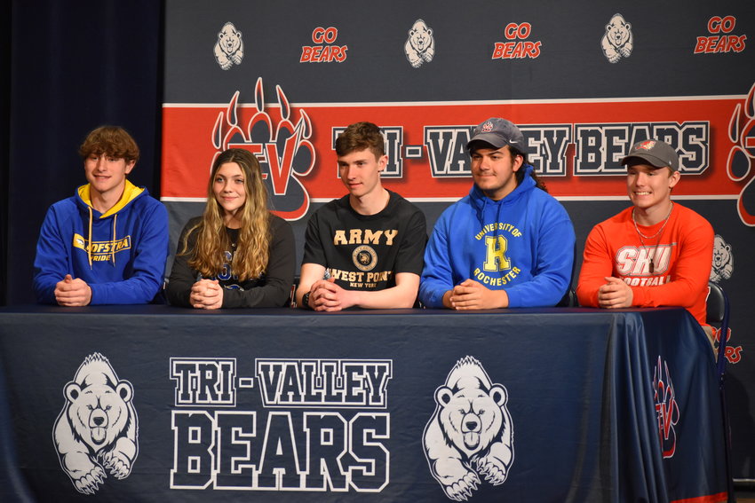 From left, Gavin Clarke, Kaylee Poppo, Adam Furman, Armaan Butler and Austin Hartman share the stage after their signing day ceremony on Thursday.