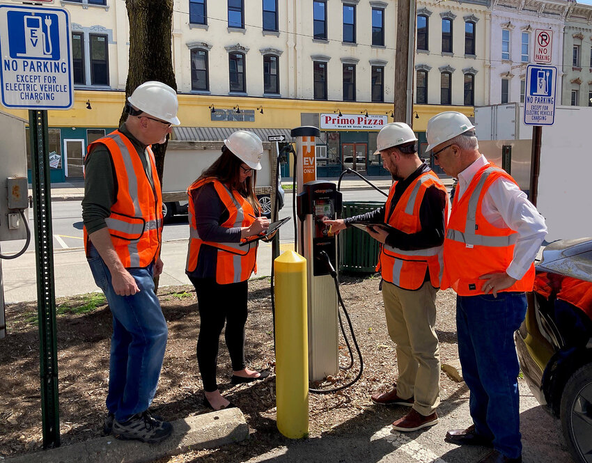 NEI employees surveying a typical EV charging station (left to right): Dale Englehart, Chief Operating Officer, Bettina Luongo, Electrical Engineer, Corey Teeple, Director of Business Development and Robert Suhosky, NEI President.