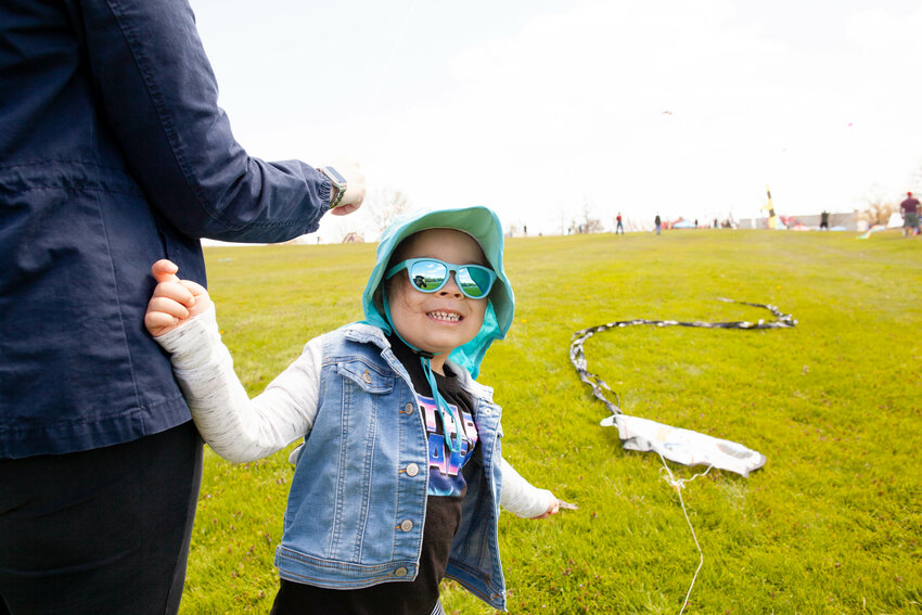 Lucy Robayo, aged 3, beamed with joy at the SUNY Sullivan Kite Festival. The festival was a fun-filled event where people of all ages gathered to fly kites and enjoy the beautiful outdoors
