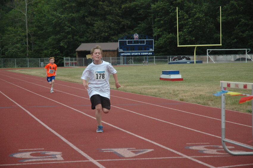 Chase Sheeley approaches the finish line with his friend, Bradley Kenney, right on his tail. The pair of future track stars duked it out for first place in the 1st Annual Veteran&rsquo;s 5K at Tri-Valley Secondary School in Grahamsville.