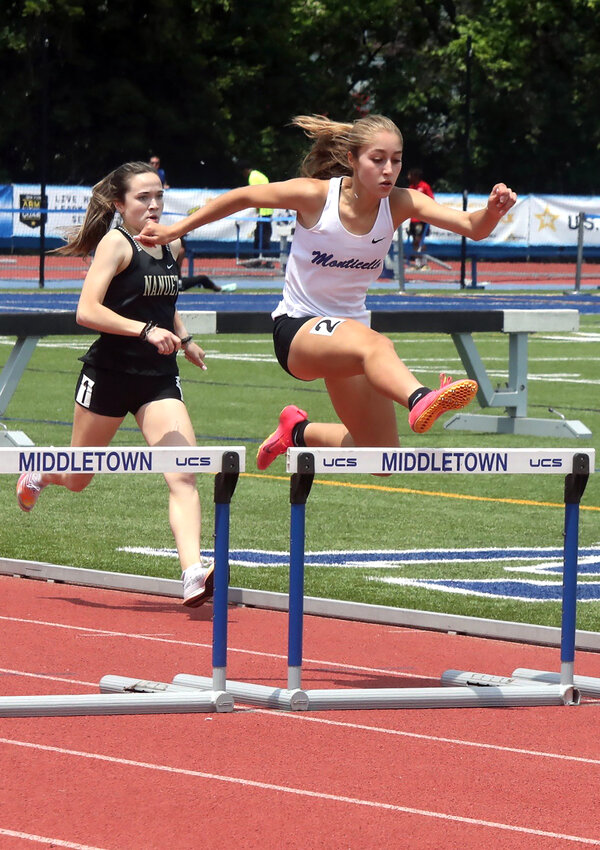 Monticello senior Taina DeJesus gracefully clears a hurdle in the 400 intermediate hurdles championship to garner her second medal of the New York State Public High School Athletic Association (NYSPHSAA) track and field championships. She finished fourth in the Division I race and sixth in the Federation Championship race setting personal best times in both races of 1:03.67 in the D-1 race and 1:03.62 in the Federation race.