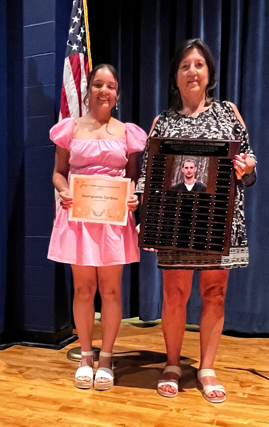Senior Georgeanne Cardona proudly receives the David F. Curreri Memorial Scholarship from Dawn Curreri. The scholarship, given in David&rsquo;s name has been awarded since 2010. Cardona was also named the Most Valuable Female Athlete.
