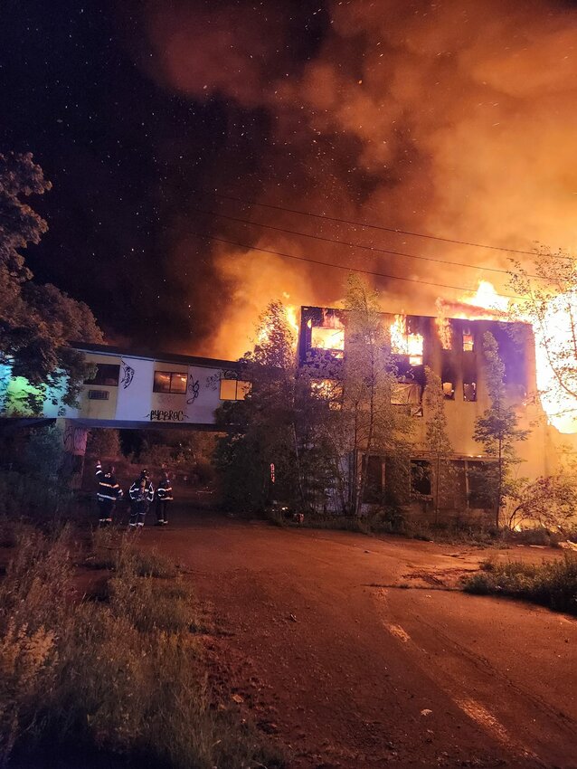 A massive fire at the Pines Hotel required the efforts of 25 fire departments and over six hours to finally bring it under control, reducing the once-standing buildings to a heap of rubble.