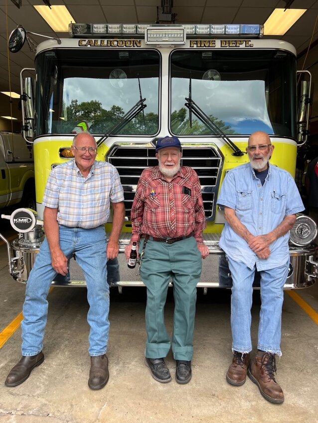 Firemen Earl Kinney, Pete Cummings, and celebrant Frank Hahn rest on a Callicoon fire truck during Hahn&rsquo;s party highlighting his 60 years in the fire service.