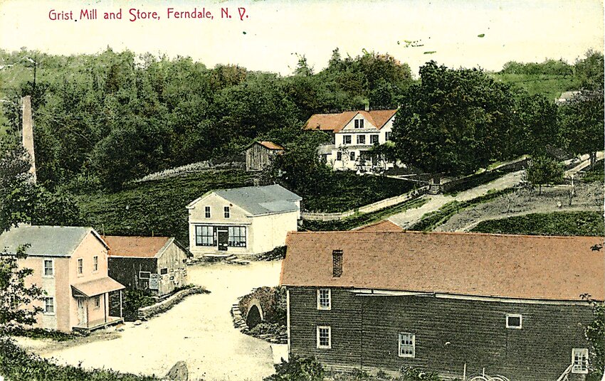 Ferndale&rsquo;s marketplace:    This intersection in the town of Liberty has changed a few times. The hamlet was known as Liberty Falls in its early days, but with the advent of train service, the name was causing havoc with the mail, and so it is said the name was changed to Ferndale. The grist mill and original stone bridge are evident in this postcard from the early 1900s. The chimney on the left is a reminder of the tannery that was once located in the hamlet, of which nothing remains. The mill pond, which was drained away long ago, was fed by the Middle Mongaup River which still wends its way through the town en route to Swinging Bridge Reservoir.