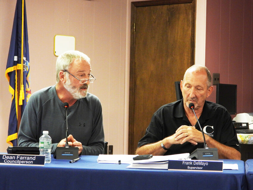 Town Board Member Dean Farrand, left, with Town Supervisor Frank DeMayo, discussed the need to follow the due processes with the meeting attendees.