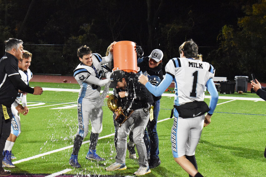 Offensive Coordinator Justin Diehl is given a gatorade shower after completing the comeback win over Pawling.
