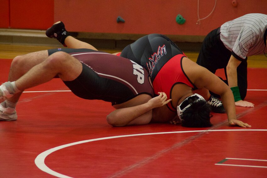 Liberty&rsquo;s Elmer Son Vicente pins New Paltz wrestler Hunter Holmes to the mat to earn six points for the RedHawks.