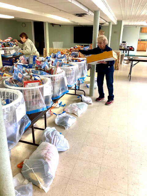 Volunteers from the church help to pack bags of food to give back to the community.