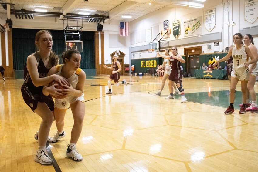 Eldred guard Avery Moscatiello attempts to pull the ball away from Olivia Stickle.