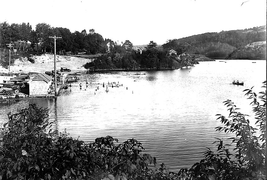 In the swim&mdash;then and now:       This vintage photo of the lake at Jeffersonville is possibly a century old or older, from a local photographer whose name has been lost to time. To the left (outside of the frame) was the hotel that perched on the rim of the lake, above a large parking area and an adjacent roped swimming  area. At the time this image was recorded, the lake was a welcome source for recreation, though its dam&rsquo;s fate could not be foreseen then. Even now, those concerned about the lake are awaiting results of a flood study to determine what the future may hold.