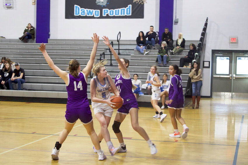 Ella Herbert drives to the basket in the second half against two Monroe-Woodbury defenders. Herbert finished with six points in the loss.