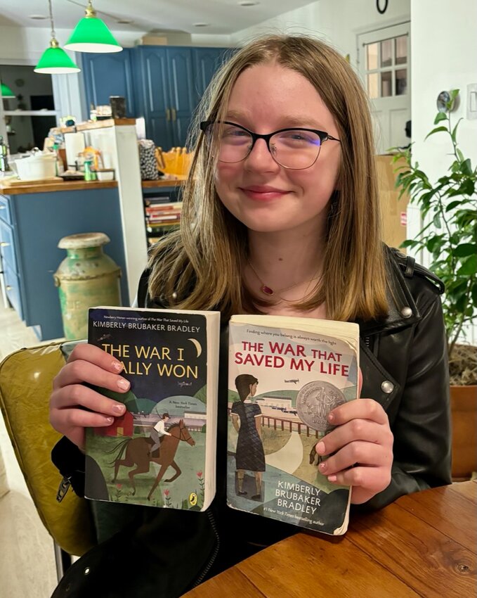 Aria Storm Partridge of Jeffersonville with her copy of The War That Saved My LIfe and its sequel.